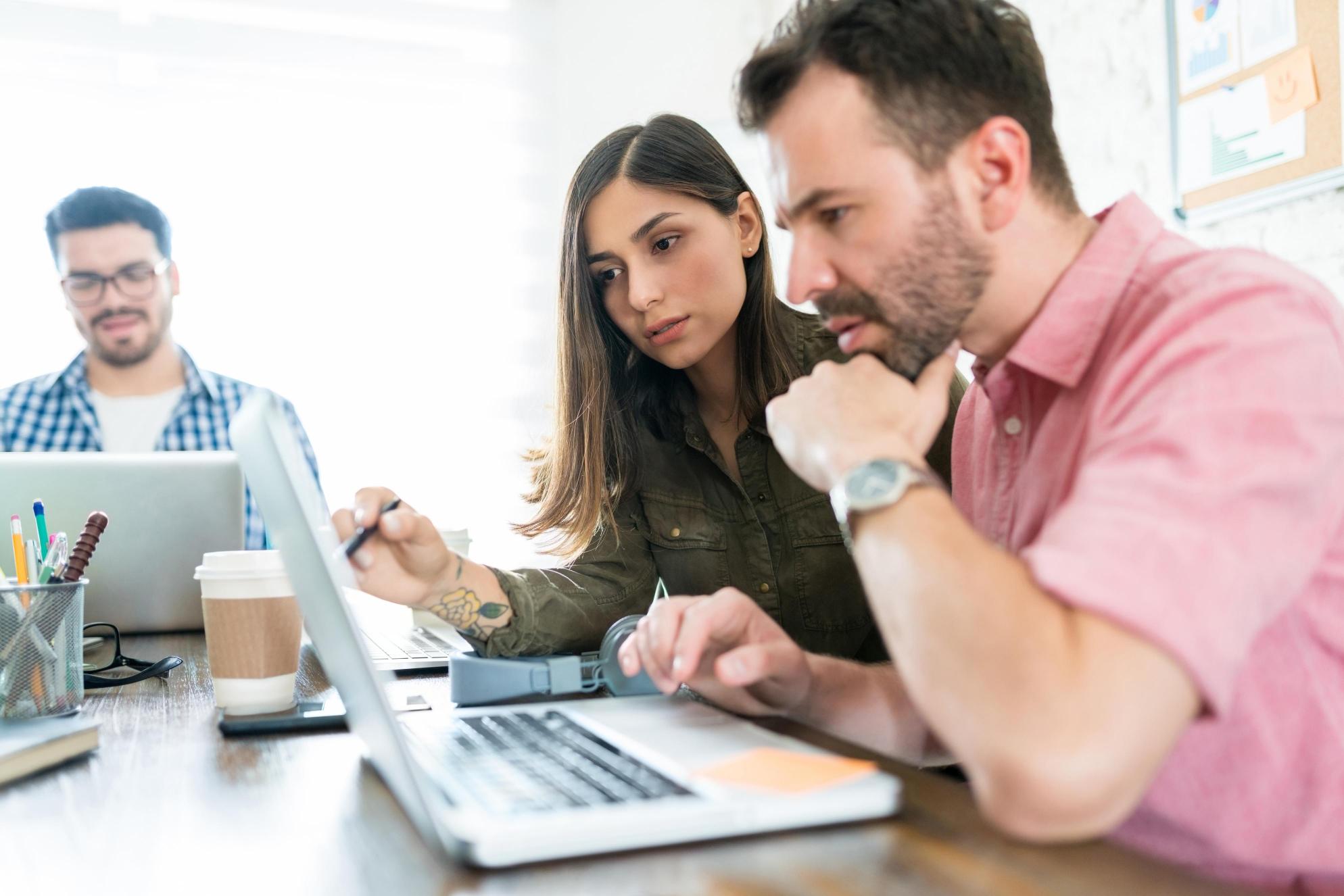 male-female-colleagues-planning-strategy-laptop-office-desk (1) (1)